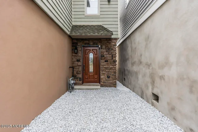 a view of a hallway with wooden walls