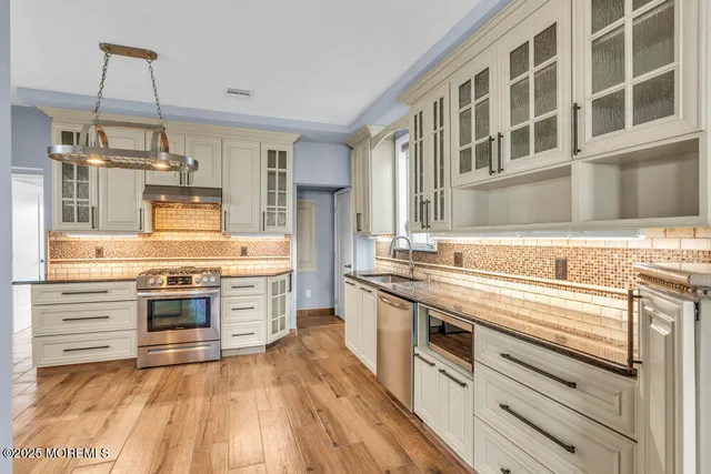 a view of a room with wooden floor windows and a chandelier