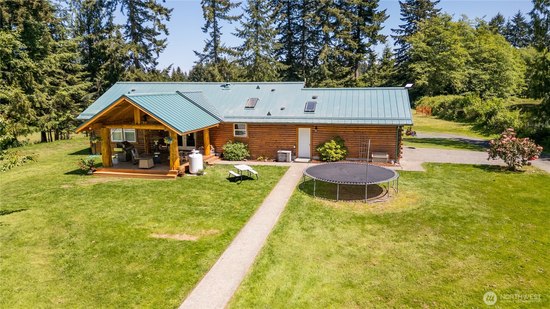 134 Bishop Road Port Angeles, WA 98363 - Photo 38 of 38 a backyard of a house with yard and outdoor seating