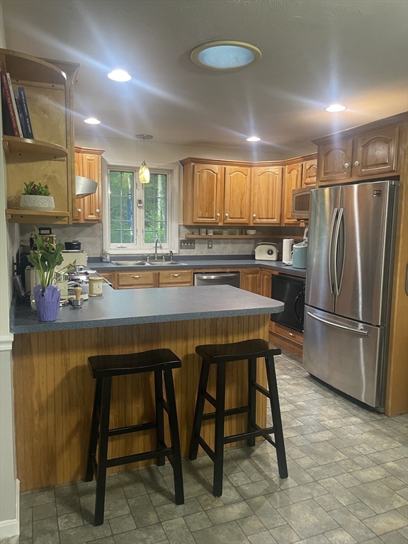 290 Woods Road Barre, MA 01005 - Photo 4 of 13 a kitchen with a table chairs refrigerator and cabinets