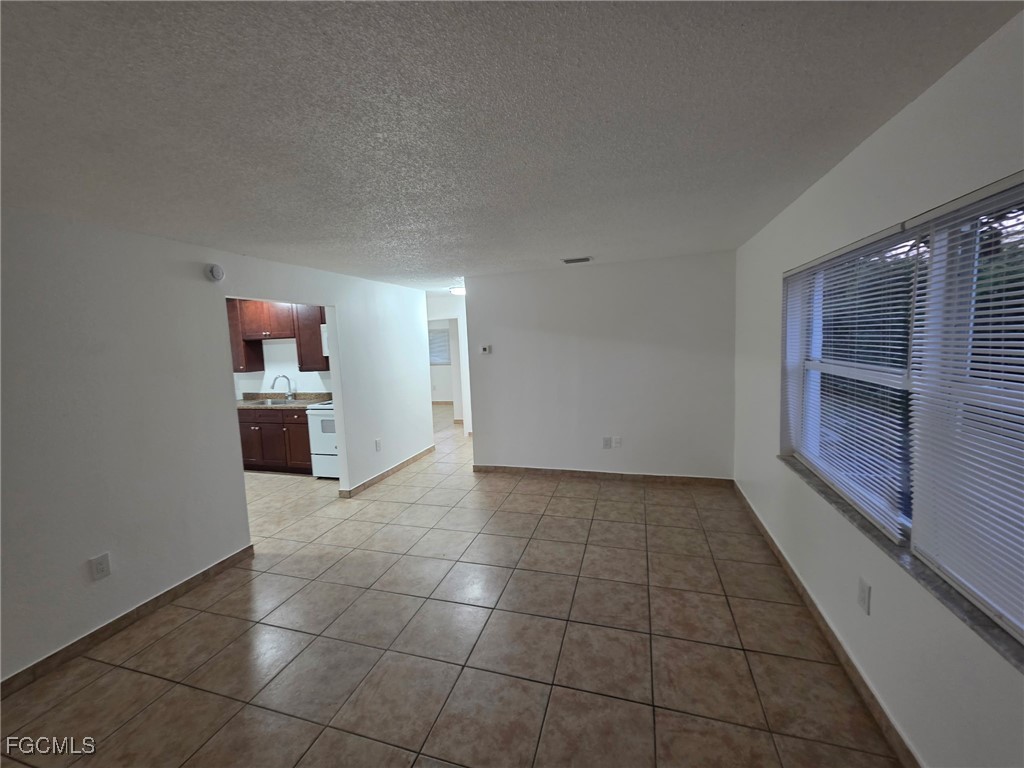 2148 Dora Street, Unit 11 Fort Myers, FL 33901 - Photo 2 of 10 a view of kitchen with refrigerator and window