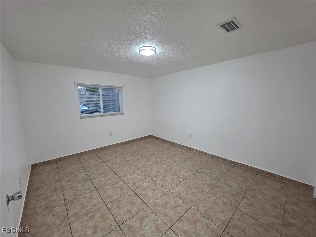 2148 Dora Street, Unit 11 Fort Myers, FL 33901 - Photo 3 of 10 an empty room with a empty space and windows