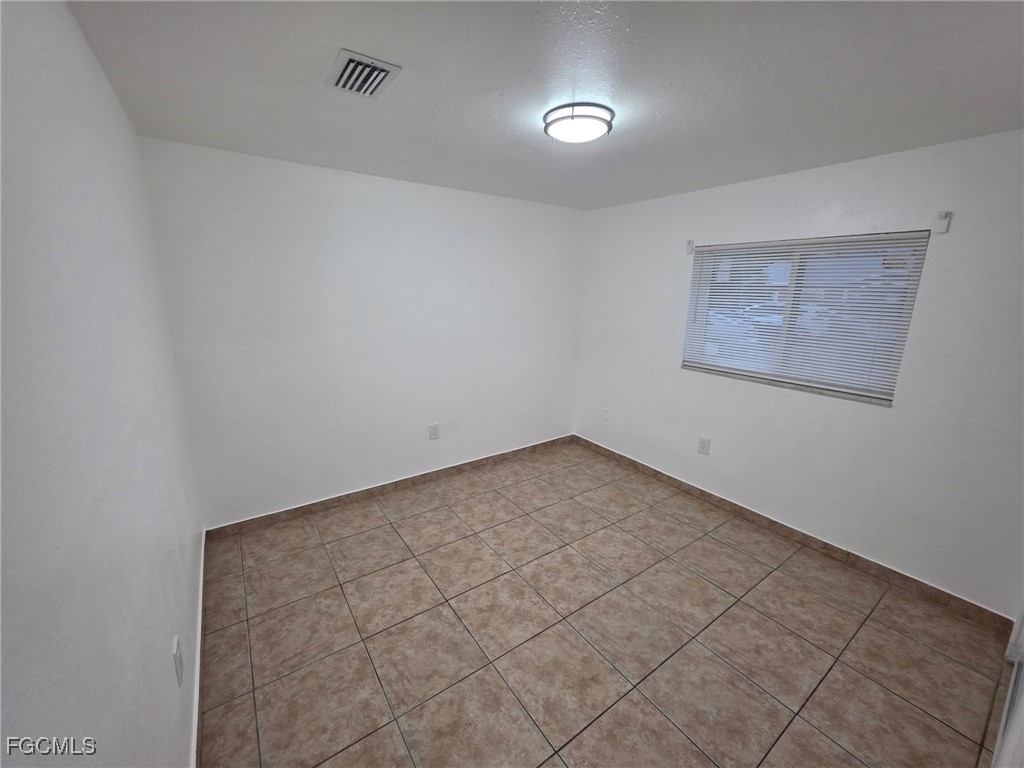 2148 Dora Street, Unit 11 Fort Myers, FL 33901 - Photo 5 of 10 an empty room with a workbench