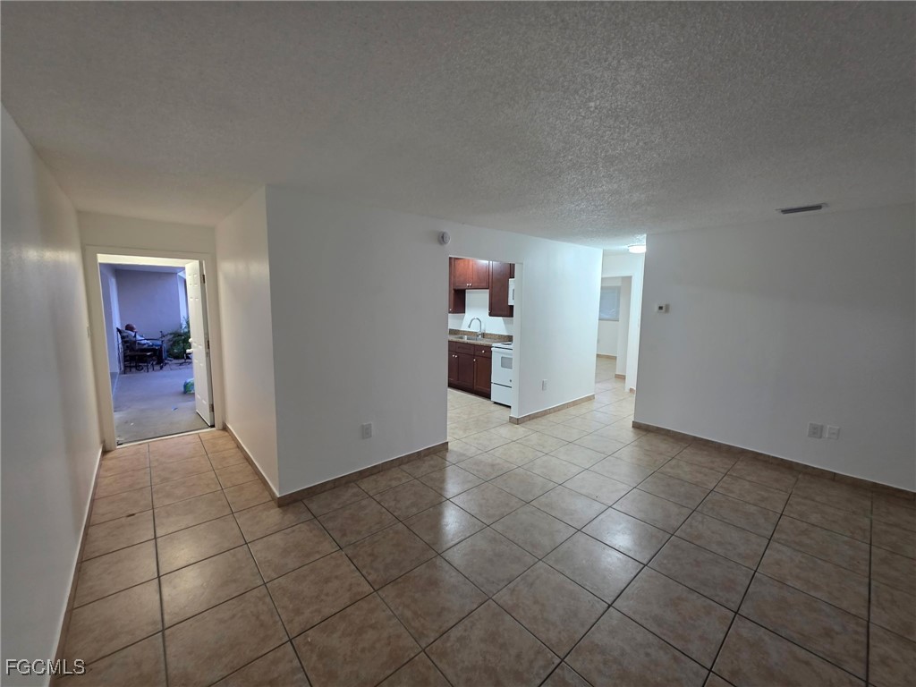 2148 Dora Street, Unit 11 Fort Myers, FL 33901 - Photo 8 of 10 an empty room & kitchen space with an empty room