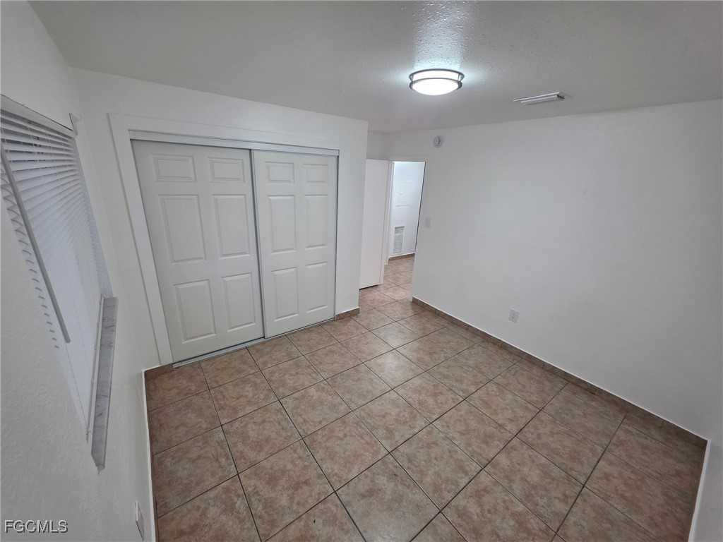 2148 Dora Street, Unit 11 Fort Myers, FL 33901 - Photo 10 of 10 an empty room with a workbench