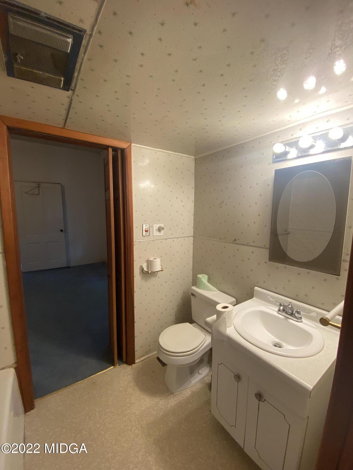 2949 South Lizella Road Lizella, GA 31052 - Photo 6 of 10 a bathroom with a sink toilet and shower