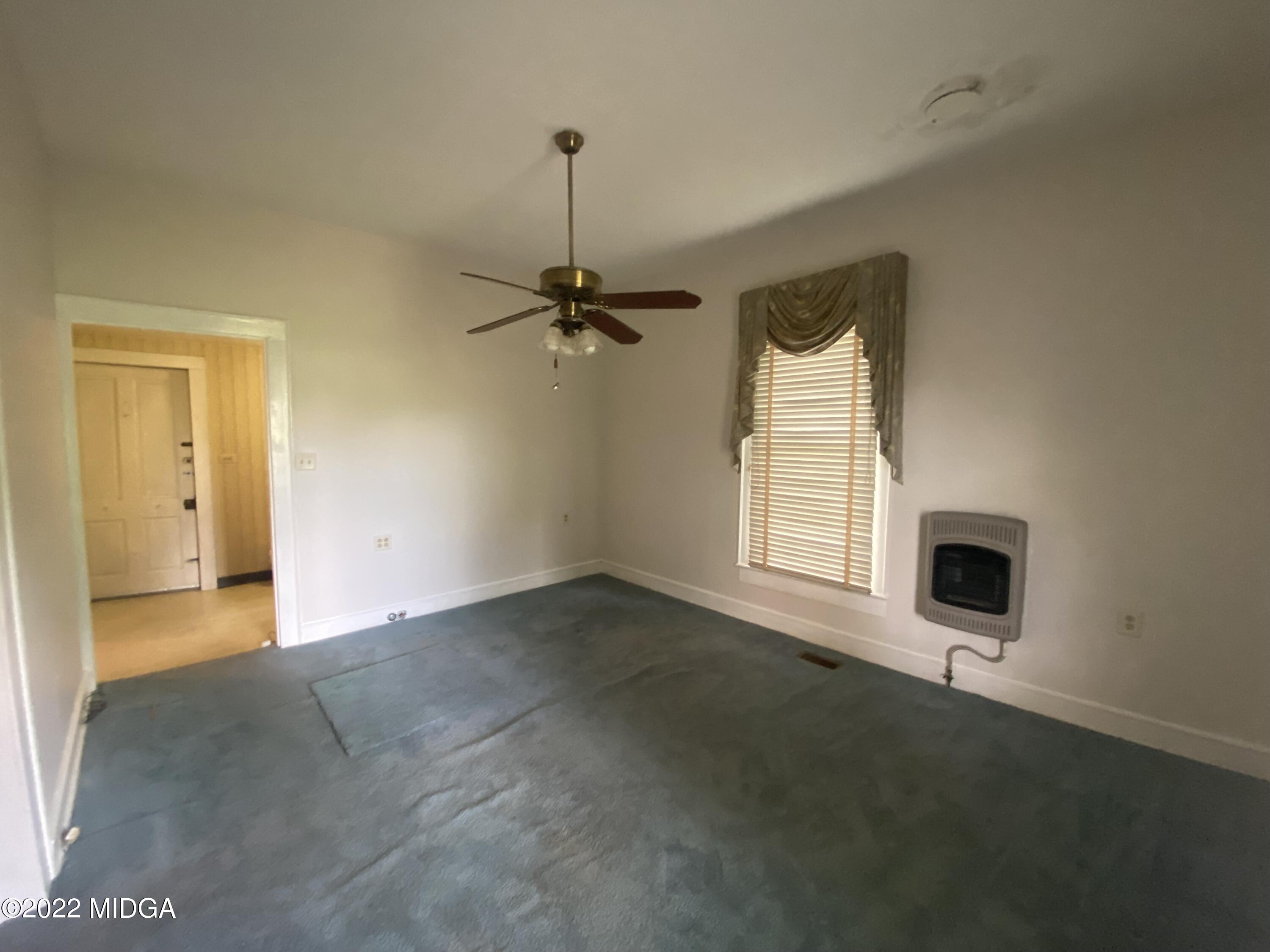 2949 South Lizella Road Lizella, GA 31052 - Photo 9 of 10 a view of an empty room with a fireplace and a window