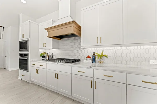 a kitchen with stainless steel appliances white cabinets and a sink