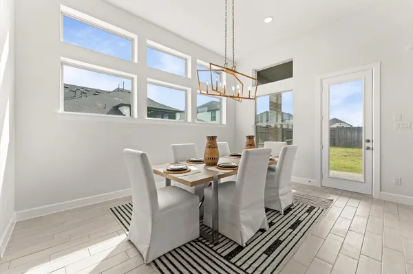 a dining room with furniture and wooden floor