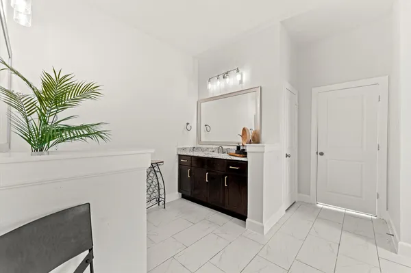 a living room with a sink and a mirror