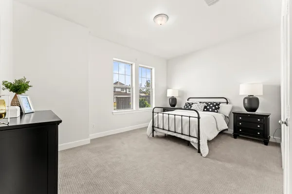 a bedroom with a bed and window