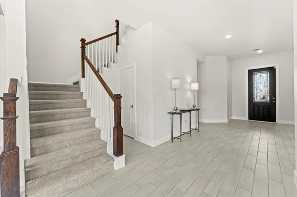 a view of entryway and hall with wooden floor