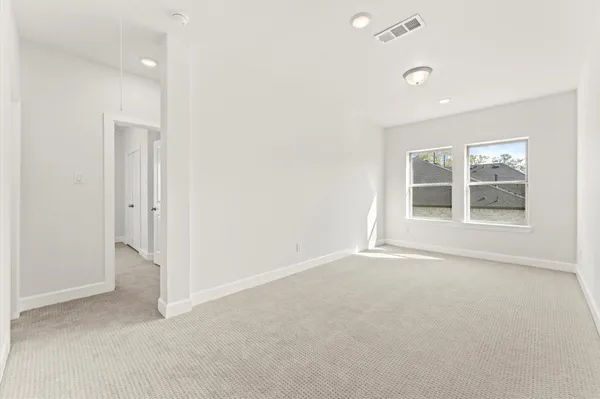 an empty room with windows and closet
