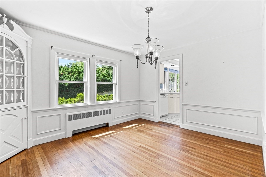 6 Old Colony Road Arlington, MA 02474 - Photo 4 of 15 a view of an empty room with wooden floor and a window