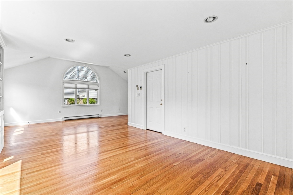 6 Old Colony Road Arlington, MA 02474 - Photo 9 of 15 an empty room with wooden floor cabinet and windows