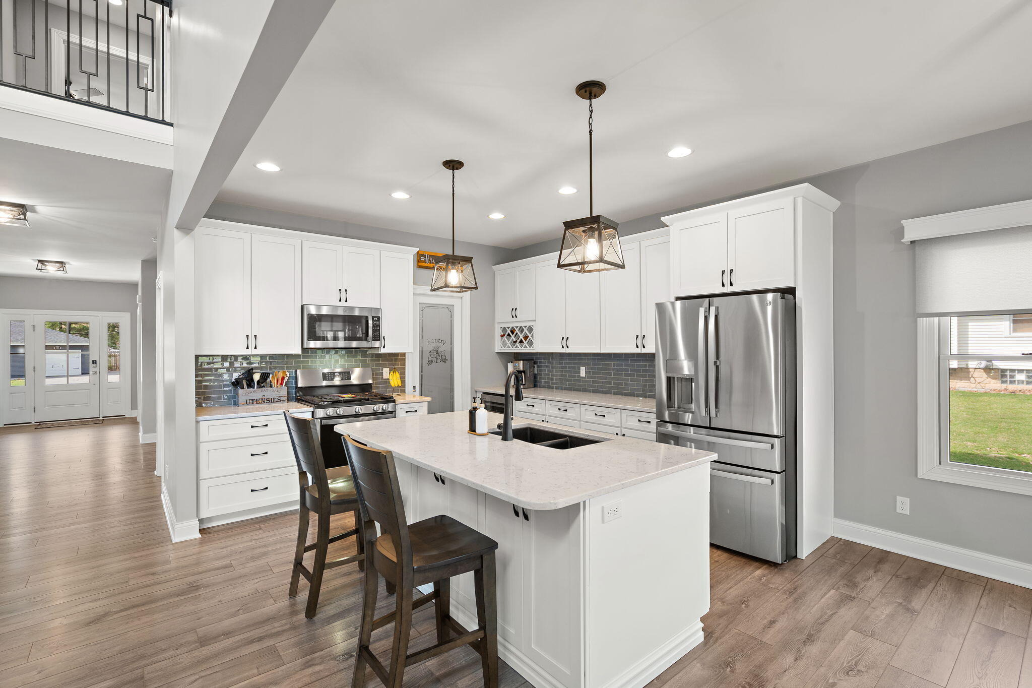 512 West Joliet Street Crown Point, IN 46307 - Photo 11 of 47 a kitchen with stainless steel appliances a refrigerator a stove a sink dishwasher a dining table and chairs with wooden floor