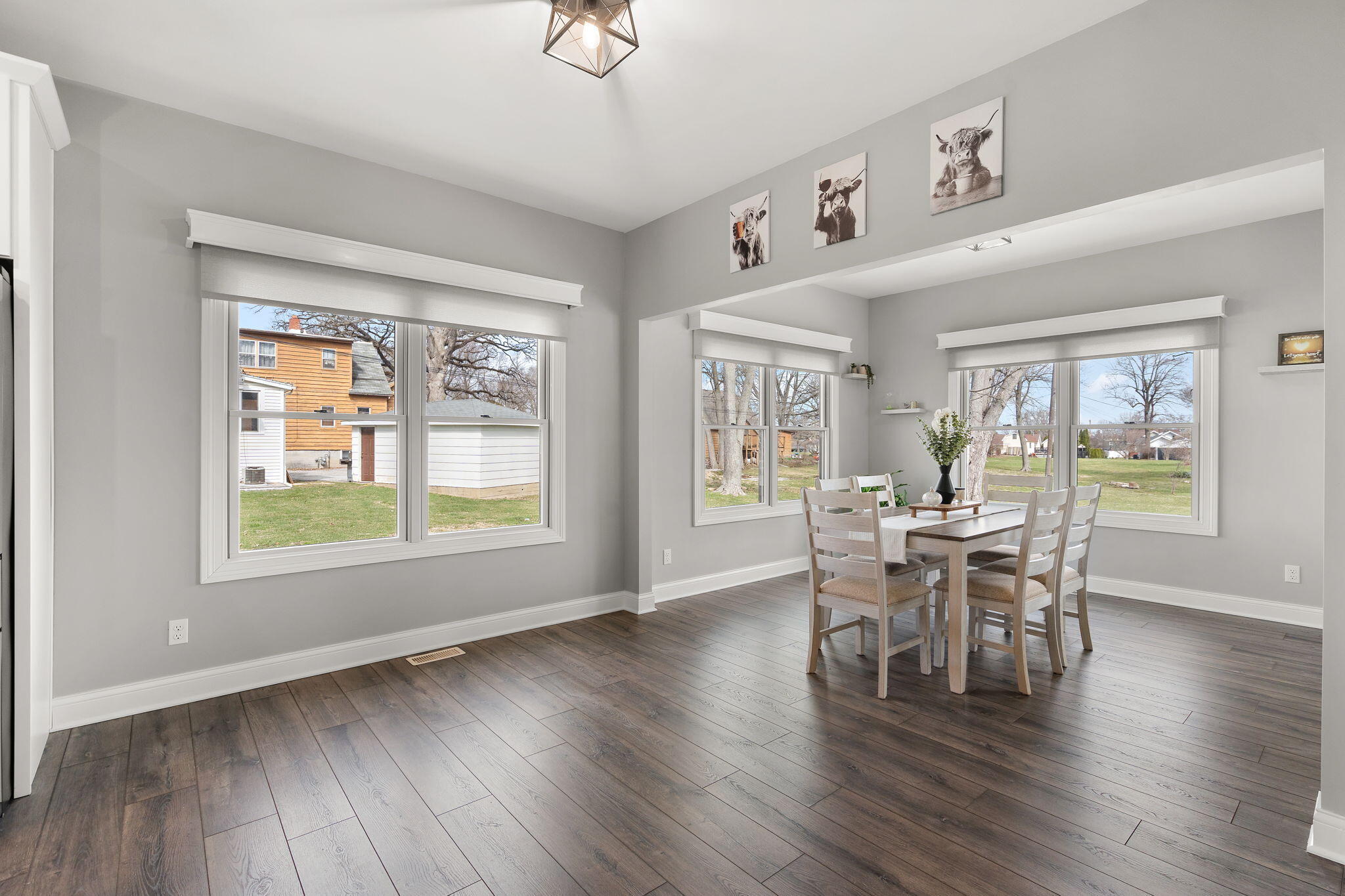 512 West Joliet Street Crown Point, IN 46307 - Photo 13 of 47 a dining room with wooden floor a chandelier a glass table and chairs
