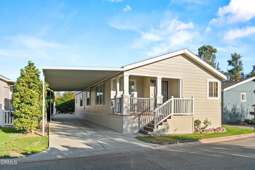 a front view of a house with a porch and glass windows