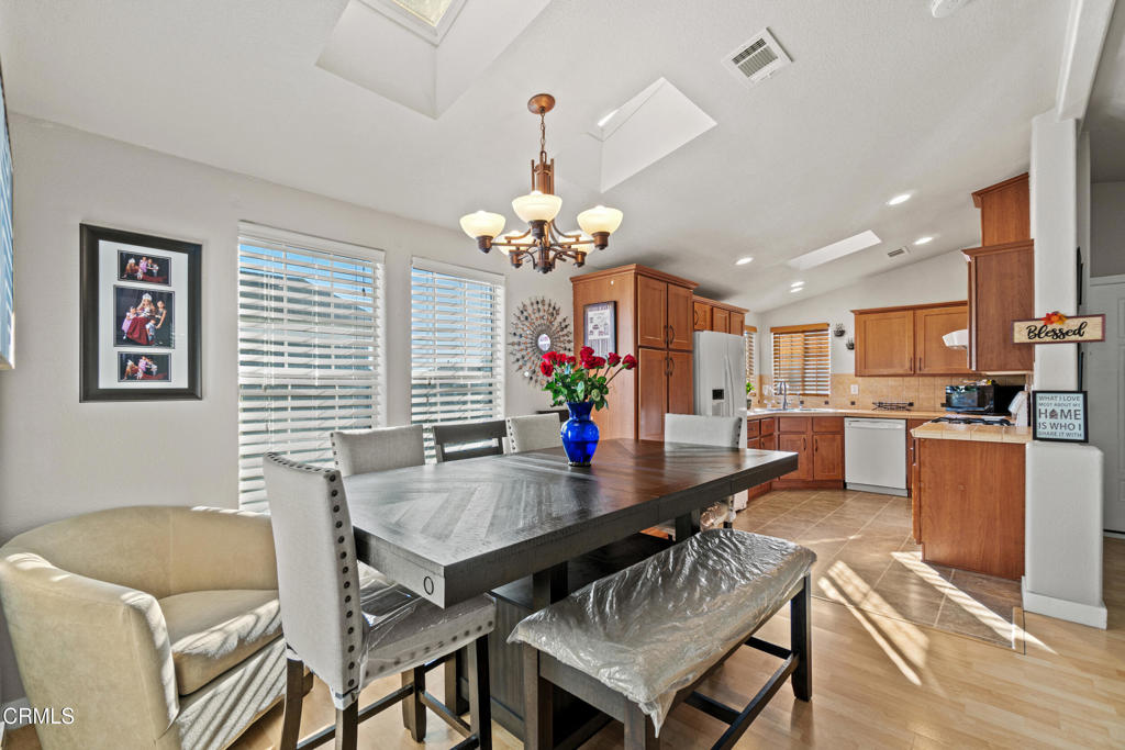 24 Via Rosal, Unit 24 Camarillo, CA 93012 - Photo 13 of 40 a view of a dining room with furniture and a chandelier