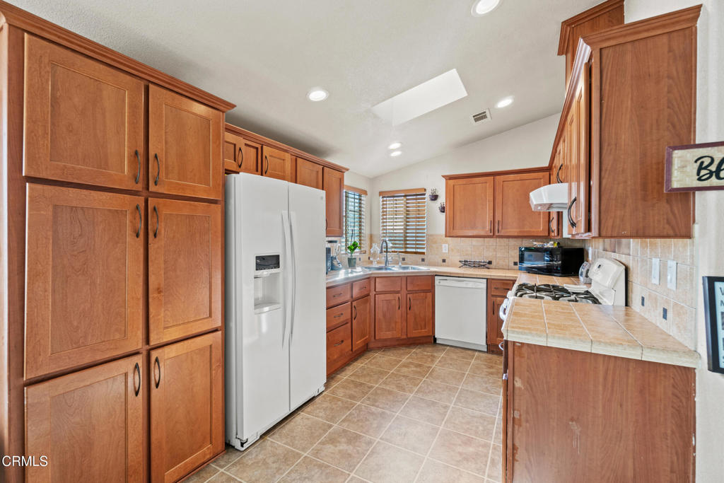 24 Via Rosal, Unit 24 Camarillo, CA 93012 - Photo 15 of 40 a kitchen with a refrigerator a sink and dishwasher