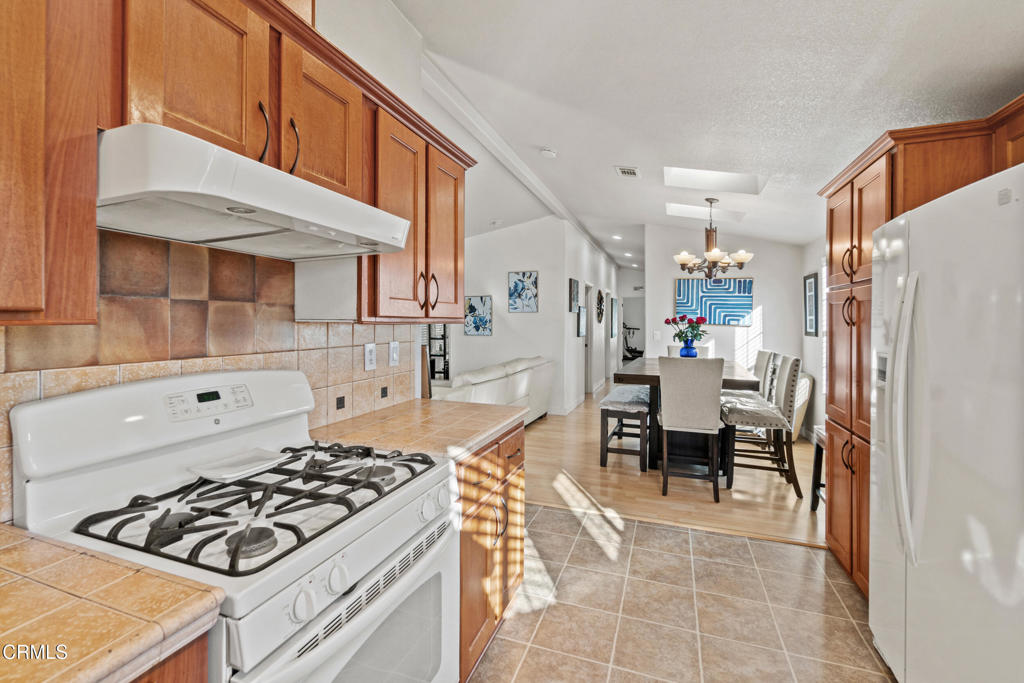 24 Via Rosal, Unit 24 Camarillo, CA 93012 - Photo 17 of 40 a kitchen with stainless steel appliances granite countertop a stove a sink and a refrigerator