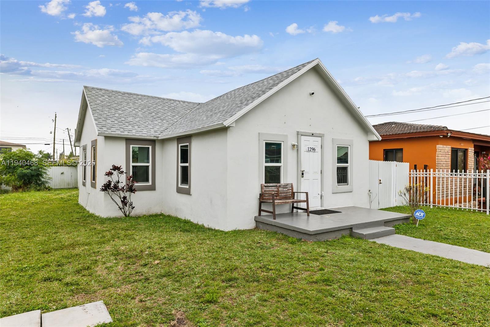 a view of a house with backyard and sitting area