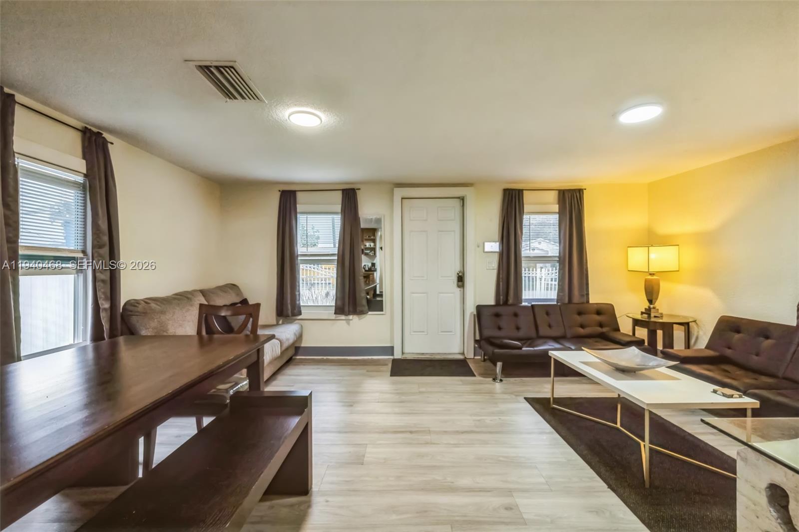 1296 Northwest 72nd Street Miami, FL 33147 - Photo 5 of 12 a living room with furniture and wooden floor