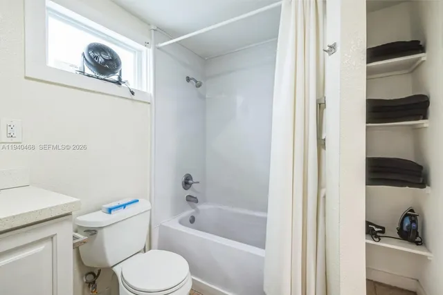 a white toilet sitting next to a bathroom sink
