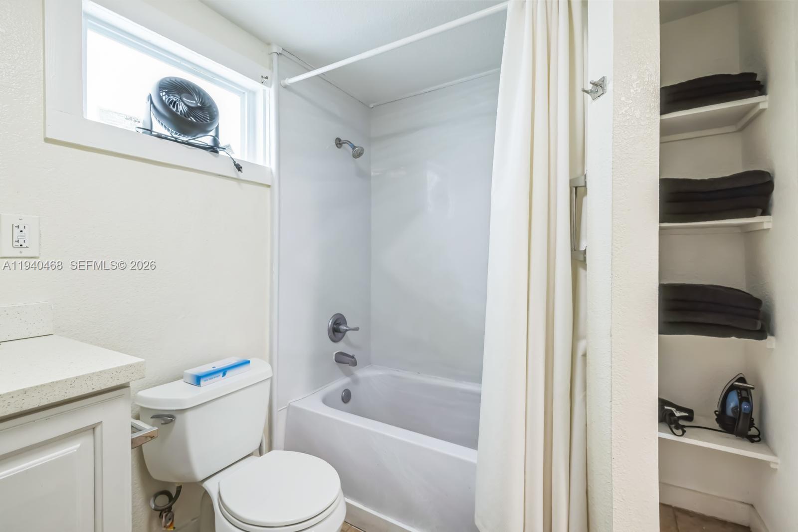 1296 Northwest 72nd Street Miami, FL 33147 - Photo 6 of 12 a white toilet sitting next to a bathroom sink