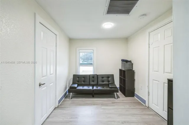 a living room with a bed furniture and a window