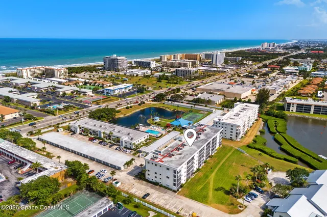 an aerial view of residential building and ocean