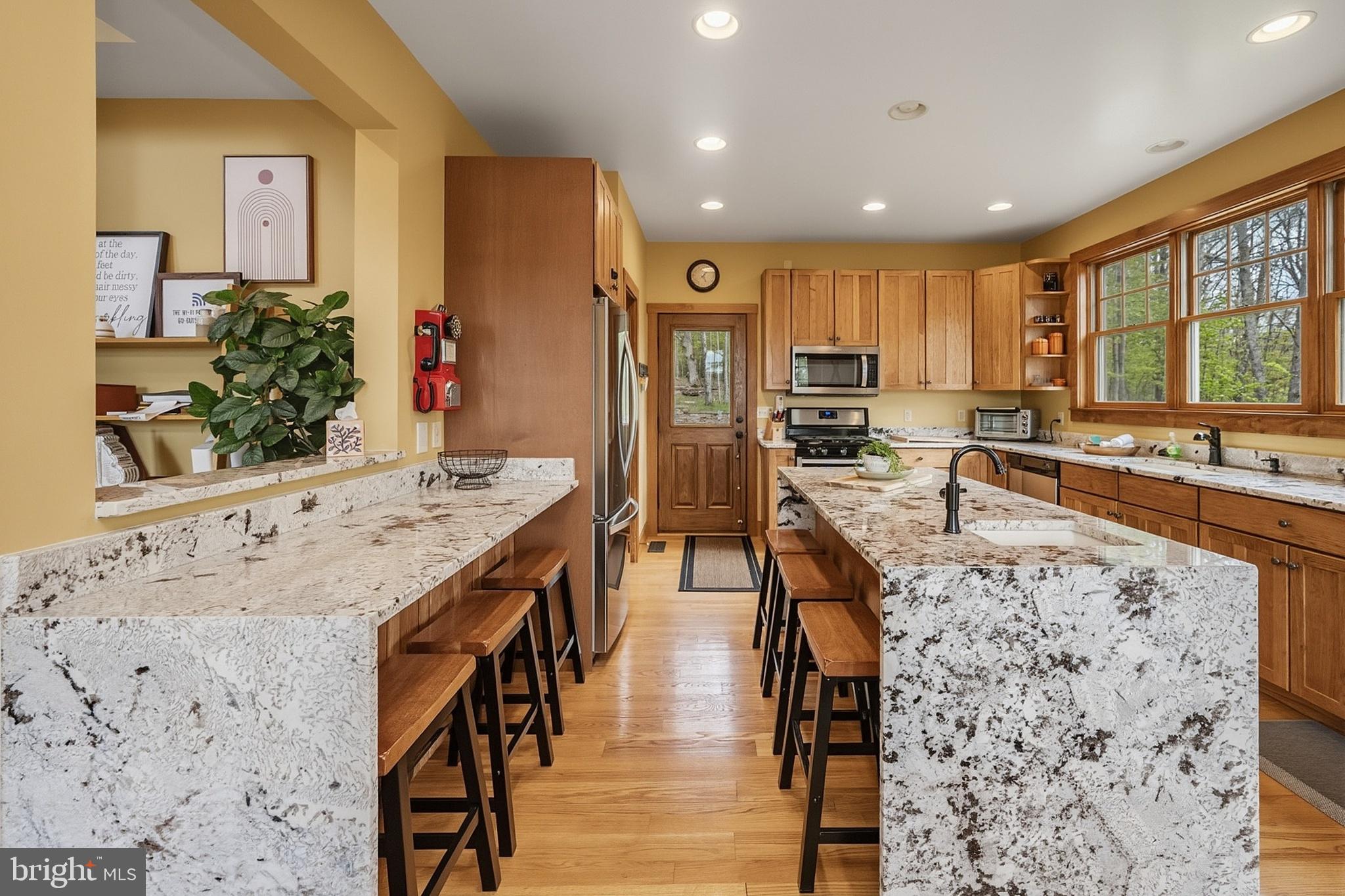 185 Ruta Lane Swanton, MD 21561 - Photo 17 of 81 a kitchen with stainless steel appliances kitchen island granite countertop a stove refrigerator and cabinets