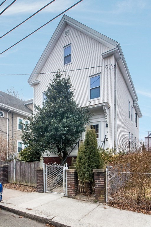 a view of a white house with large windows