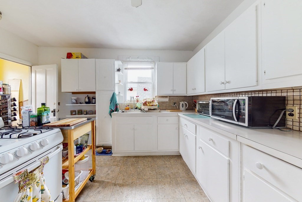 26 Clark Street Somerville, MA 02143 - Photo 15 of 32 a kitchen with stainless steel appliances white cabinets and a refrigerator