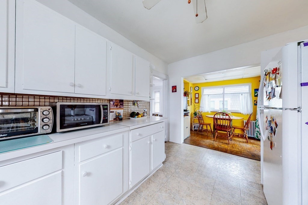 26 Clark Street Somerville, MA 02143 - Photo 16 of 32 a kitchen with stainless steel appliances a stove a sink and white cabinets