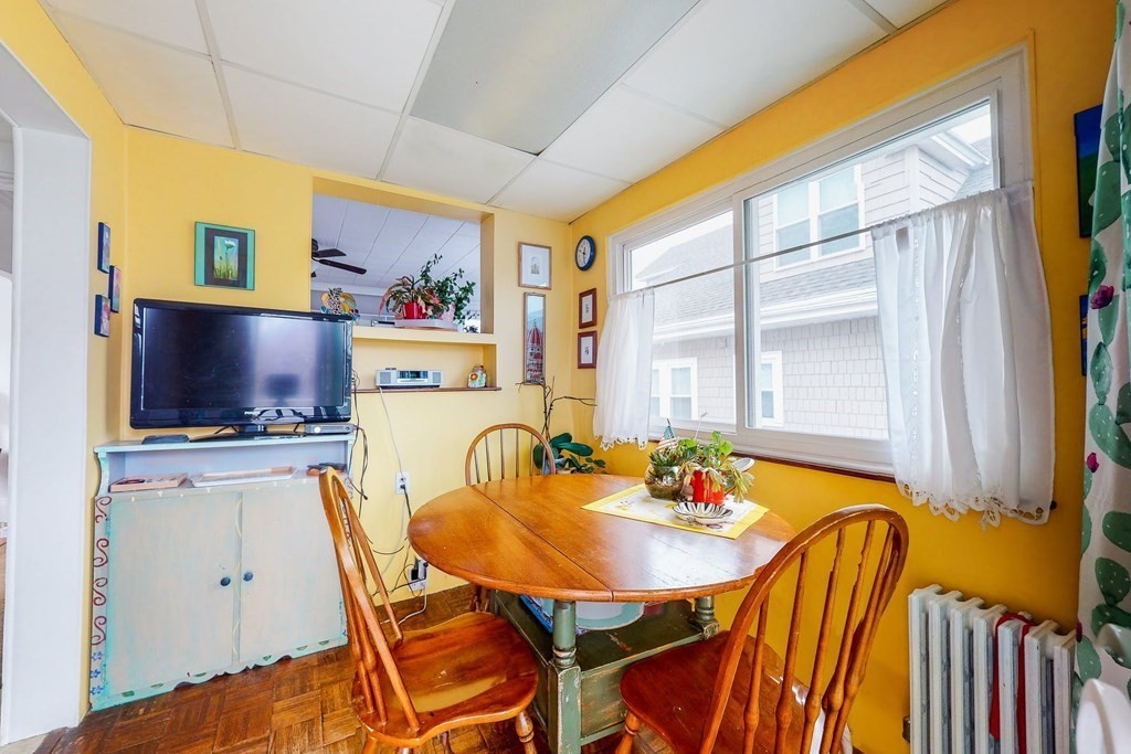 26 Clark Street Somerville, MA 02143 - Photo 17 of 32 a dining room with furniture and a flat screen tv