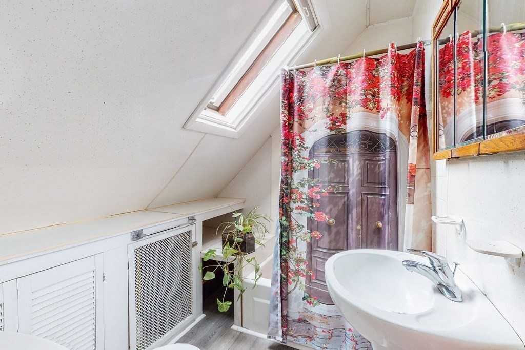 26 Clark Street Somerville, MA 02143 - Photo 19 of 32 a bathroom with a sink and a mirror