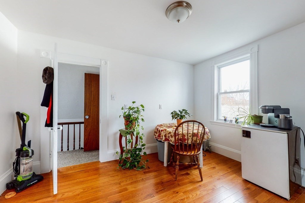 26 Clark Street Somerville, MA 02143 - Photo 21 of 32 a dining room with furniture potted plants and wooden floor