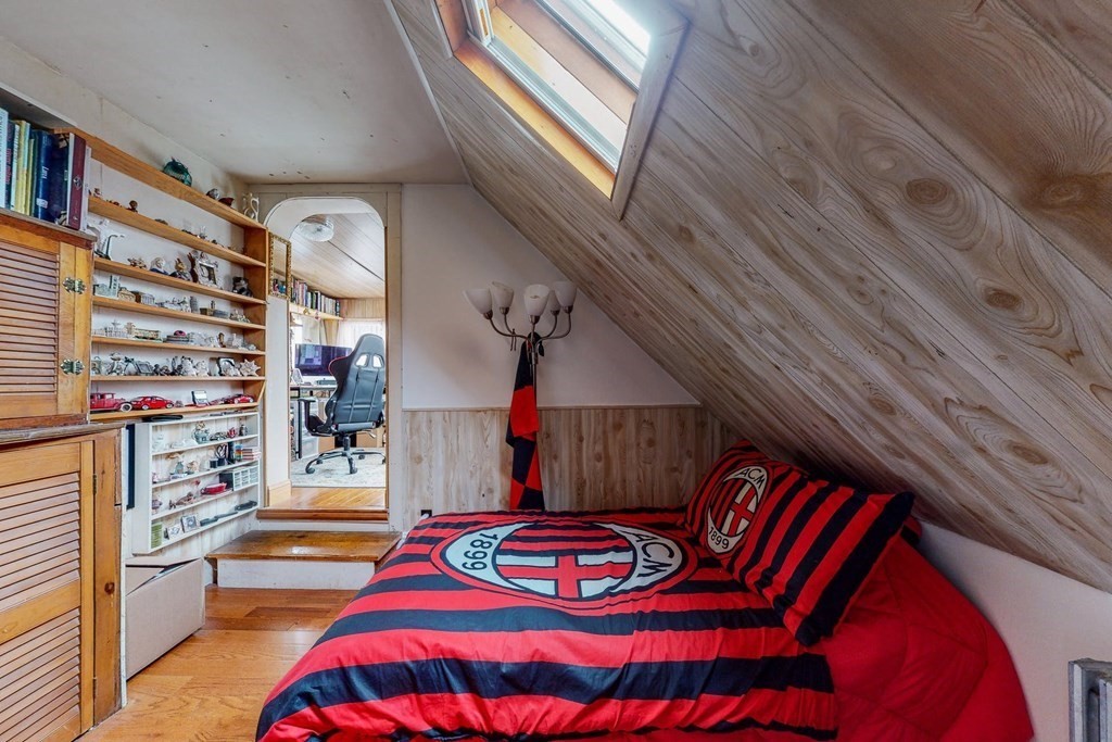 26 Clark Street Somerville, MA 02143 - Photo 22 of 32 a bedroom with a bed and a book shelf
