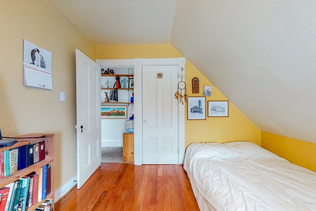 26 Clark Street Somerville, MA 02143 - Photo 24 of 32 a bedroom with a bed and a book shelf