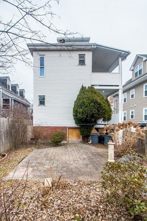 26 Clark Street Somerville, MA 02143 - Photo 26 of 32 a view of a house with a yard and potted plants
