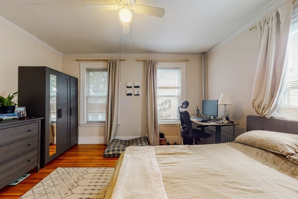 26 Clark Street Somerville, MA 02143 - Photo 5 of 32 a bedroom with a bed and wooden floor