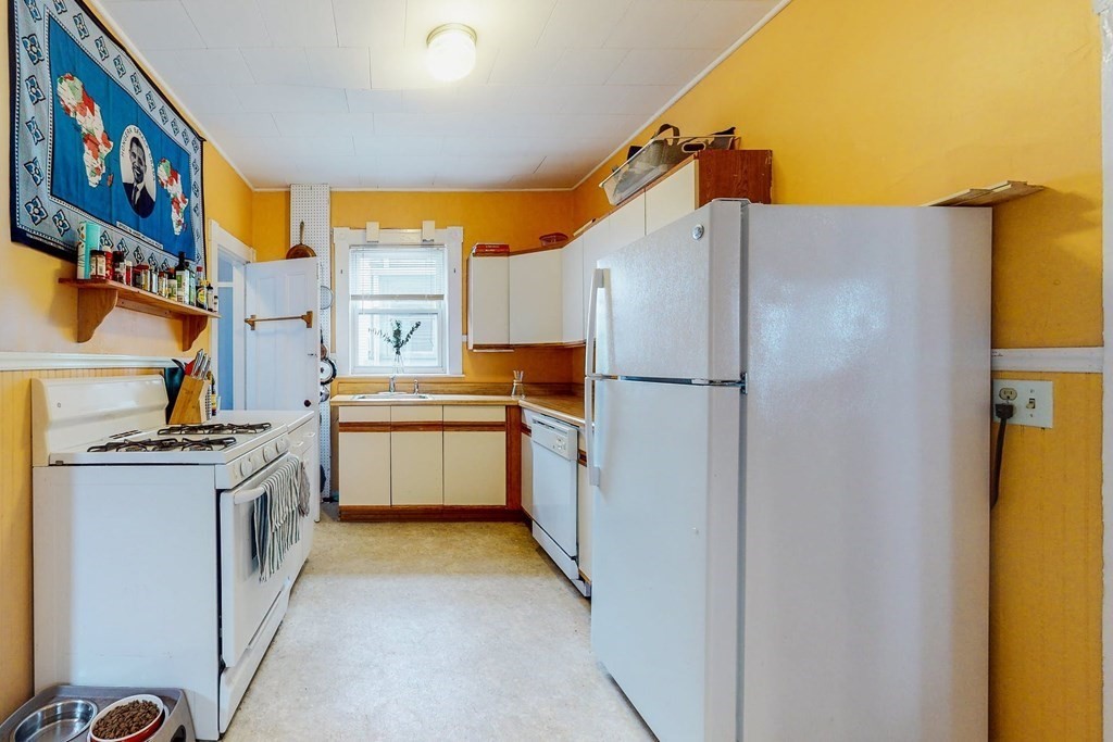 26 Clark Street Somerville, MA 02143 - Photo 7 of 32 a kitchen with stainless steel appliances a stove a refrigerator and a cabinets