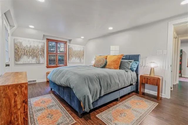 a bedroom with a large bed and a couch