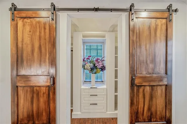 a view of walk in closet with glass door