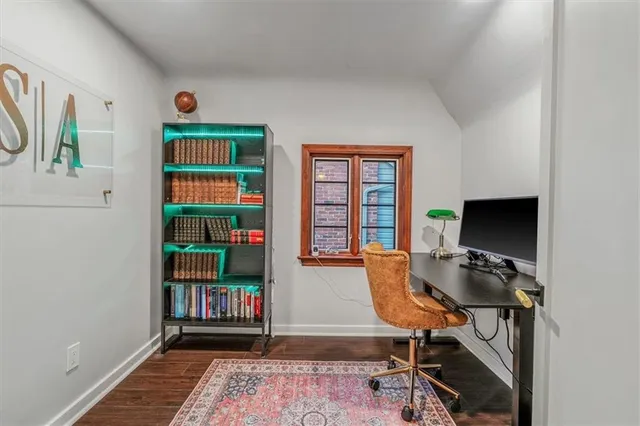 a view of a workspace with furniture and a window