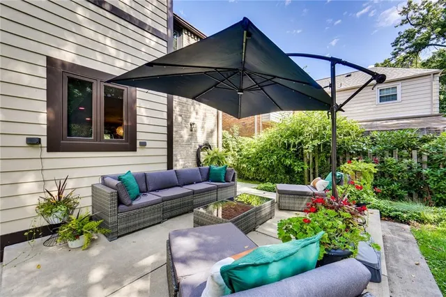 a view of patio with a table and chairs under an umbrella