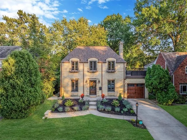 a view of a house with a yard and sitting area
