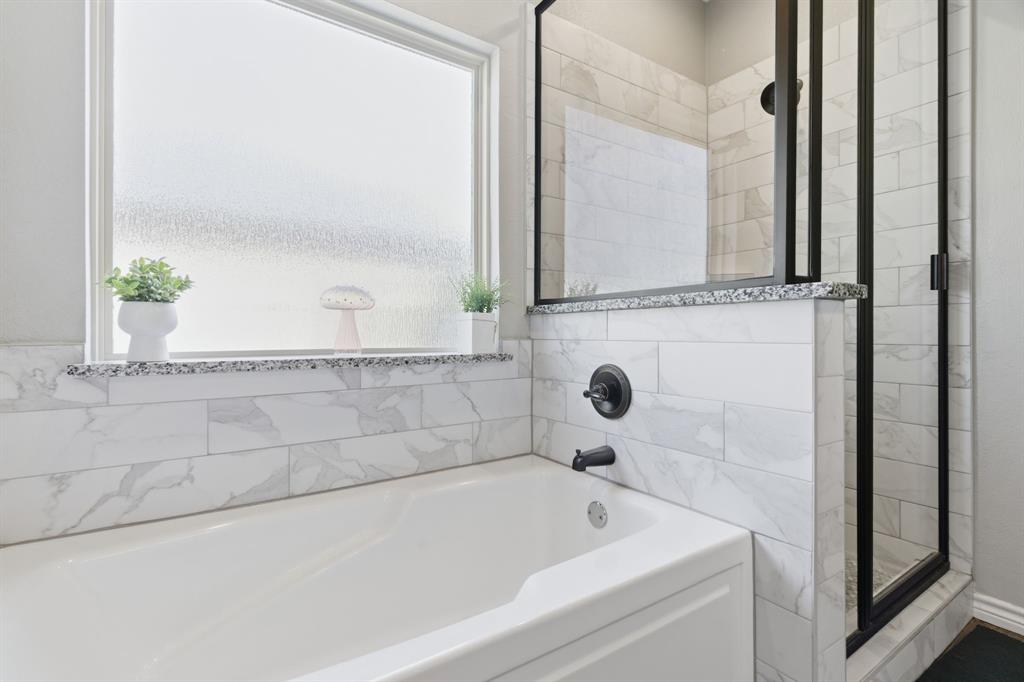 711 Hadley Lane Valley View, TX 76272 - Photo 19 of 40 Full bathroom featuring a garden tub and a shower stall