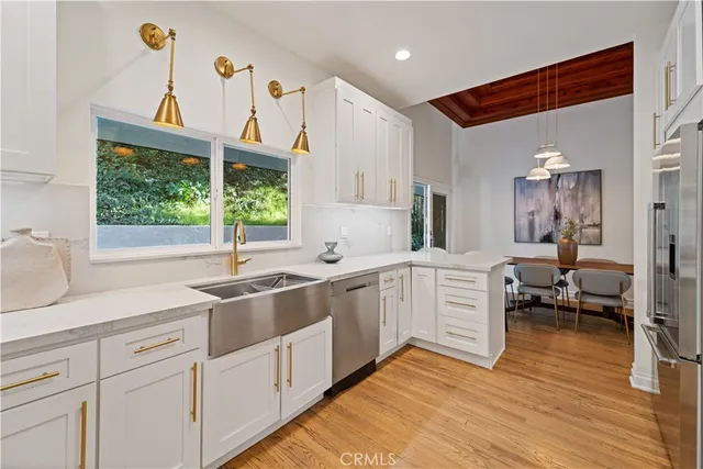 a kitchen with sink cabinets and wooden floor